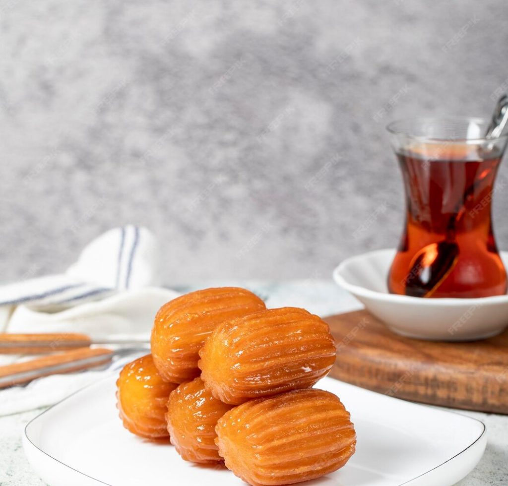 tulumba-dessert-ramadan-sweets-traditional-turkish-cuisine-delicacies-tulumba-dessert-with-syrup-gray-background_659681-11461.jpg